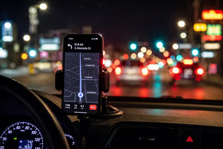 Rideshare pickup at night, map glowing on the dash | Denver Uber accident lawyer | Lionheart Injury Law